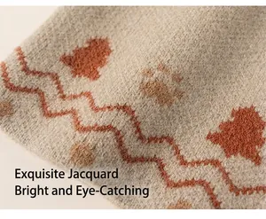 Macro detail of soft knit fabric with orange waves and brown animal paw patterns