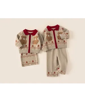 Detail of kids knit set featuring red polo collar, 3D teddy bear and festive patterns