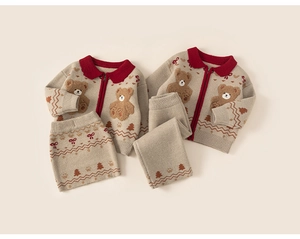 Detail of children's knit set with 3D teddy bear patch and festive jacquard pattern