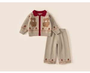 Detail of girls knit zip-up cardigan with plush bear patches and Christmas tree patterns