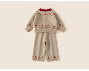 Detailed flat lay of children's beige knit sweater set with festive holiday patterns