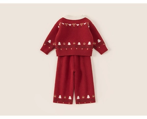 Detailed view of red knitted toddler set with festive Christmas tree and bow patterns