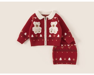 Detail of red knit two-piece dress with white bear patterns and holiday decorations