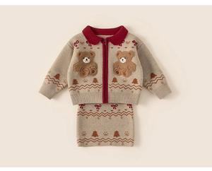 Detail of knitted cardigan with teddy bear embroidery and festive holiday patterns