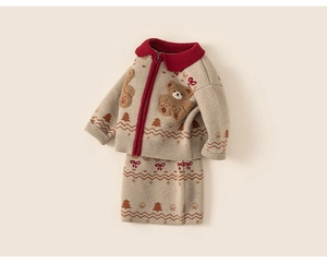Close-up of girls knitted beige cardigan and skirt set with 3D teddy bear and holiday motifs
