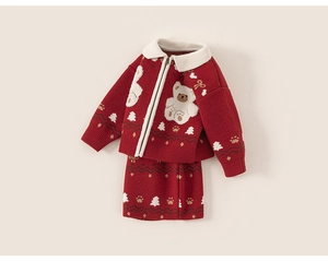 Detail of red knitted girl's dress featuring a zipper cardigan and cute white bear embroidery