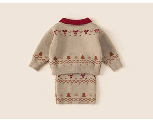 Detail of beige knit cardigan and skirt set featuring red bows and festive knit patterns