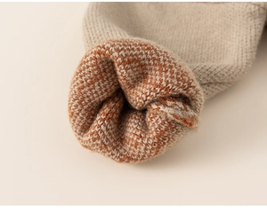 Detail of knitted cuff showing premium oatmeal and mixed orange wool texture