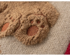 Detailed view of soft brown teddy bear paw patch on high-quality knitted fabric