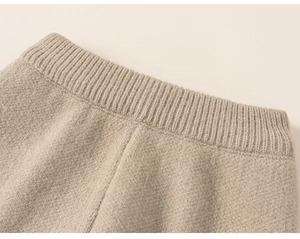 Detail of oatmeal knitted waistband showing fine ribbing and soft elastic texture