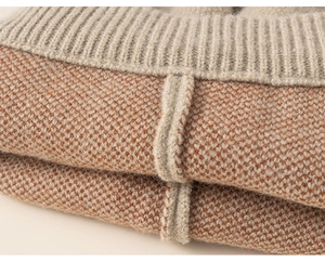 Macro shot of orange and grey knit fabric texture with ribbed edge for children's outfit