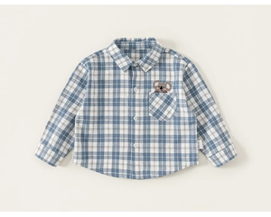 Detail of blue plaid kids shirt featuring cute koala embroidery on the chest pocket