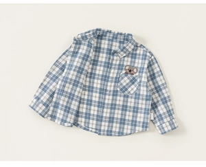 Detail of boys' blue plaid shirt with a cute koala embroidery on the pocket