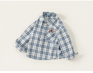 Detailed view of blue plaid cotton shirt for boys with cute koala embroidery on pocket
