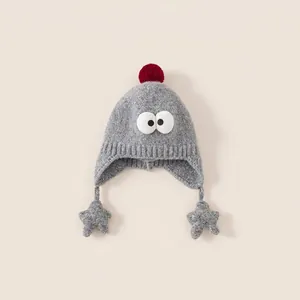 Grey knitted kids earflap hat with cartoon eyes and red pom-poms on top