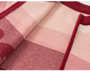 Close-up of pink knit shirt showing premium fabric texture and high-quality nylon zipper