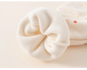 Close-up of warm fleece lining and heart print pattern on kids sweatshirt sleeve