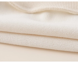 Detailed macro view of warm fleece lining and ribbed cuff on children's winter tracksuit