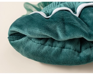 Gros plan sur le tissu en peluche verte avec bordure festonnée pour pull enfant