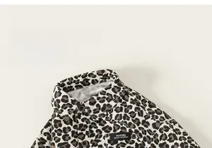 Detail view of stylish leopard print shirt featuring a classic collar and dark brown buttons