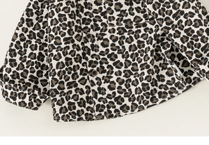 Close-up of leopard print toddler shirt showing cotton texture and front chest pocket