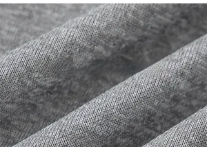 Close-up of soft grey knit fabric texture and fine stitching on children's coat