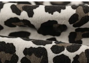 Close-up of leopard print cotton fabric texture on a trendy toddler boy shirt