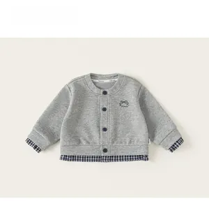 Detail of grey infant cardigan with blue plaid patchwork cuffs and bow embroidery