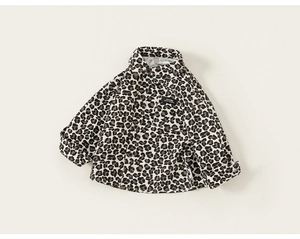 Close-up of leopard print toddler boy shirt featuring a standard collar and chest pocket