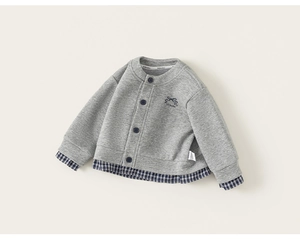 Detail of grey knitted baby cardigan with blue checkered cuffs and bow embroidery