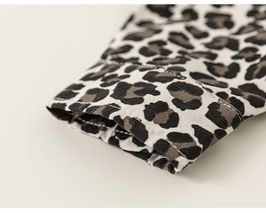Close-up of leopard print shirt cuff with fine stitching and cotton-linen texture