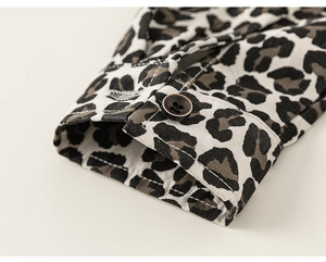 Detail view of stylish leopard print shirt cuff with fine stitching and dark button