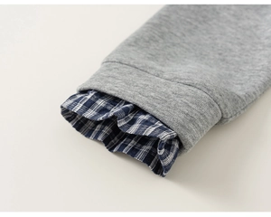 Detail of grey knit cuffs with blue plaid shirt lining for children's jacket