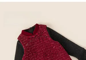 Detail of red sequin child top with traditional Chinese button and black glitter sleeves