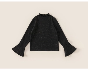 Detail of black girls' top with starry sequins, bell sleeves and ruffled neckline