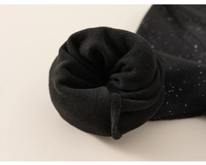 Detail of girls' sparkly black knit fabric with thick thermal fleece lining for winter warmth
