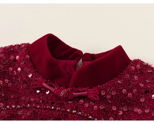 Detail of red velvet Chinese collar with handmade frog closure and beaded sequins