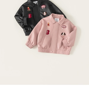 Detail view of kids PU leather jackets in black and pink with stylish embroidery patches