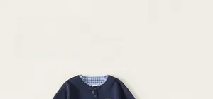 Detail of boys' navy long sleeve top with blue plaid shirt collar faux two-piece design