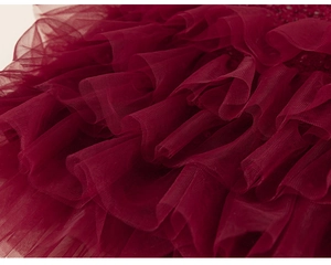 Close-up of tiered dark red mesh fabric with sequin details on a Chinese style dress