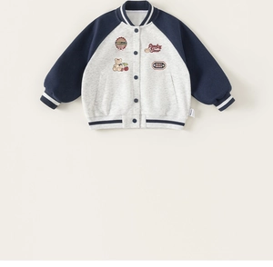Detail of kids baseball jacket showing navy blue sleeves and embroidery patches