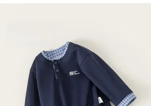 Detail of navy long sleeve sweatshirt with gingham faux-layered collar and cuffs