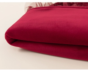 Detailed close-up of dark red velvet fabric and mesh stitching for girls princess dress