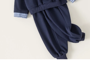 Detail view of navy blue boys' casual set with checkered patchwork on long sleeves