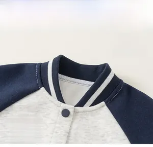Detail view of children's baseball jacket with contrast sleeves and logo embroidery