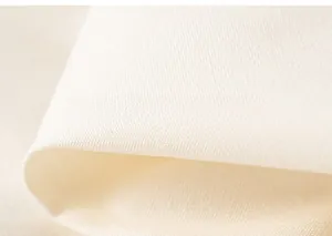 Close-up of soft breathable white woven fabric texture on girl's cotton clothing set