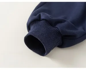 Detail of navy blue ribbed cuffs on boys casual trousers featuring high quality cotton fabric