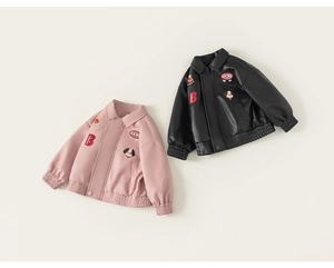 Detail of pink and black faux leather jackets with collar and embroidered patches