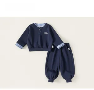 Detail view of navy blue boys' two-piece set with checkered trim and button collar design