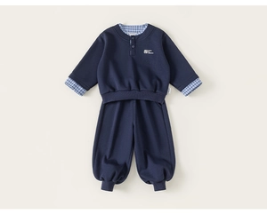 Detailed view of kids navy two-piece set featuring faux layered collar and embroidered logo